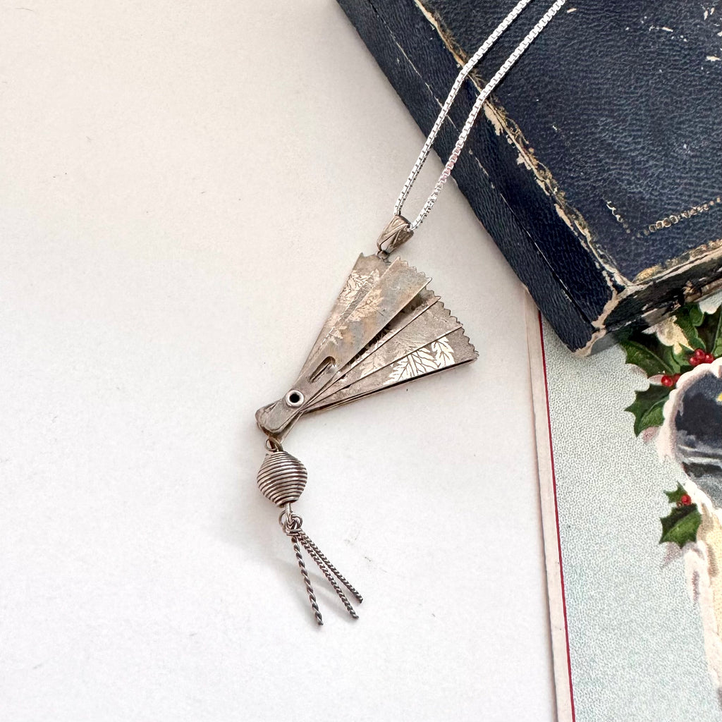 Vintage silver fan necklace on a vintage jewellery box and a vintage Christmas card.