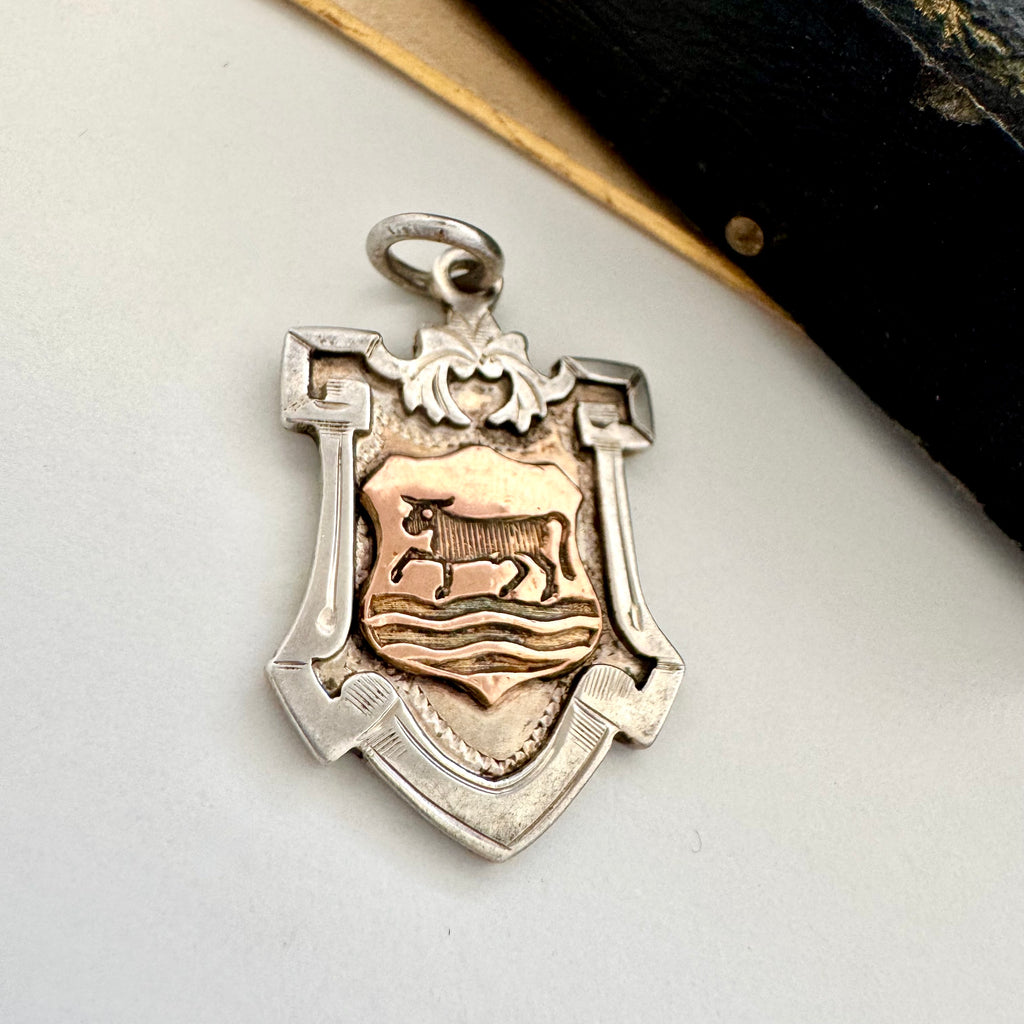 Vonk Jewellery vintage sterling silver and rose gold Fattorini watch fob with a leather vintage jewellery box in the background