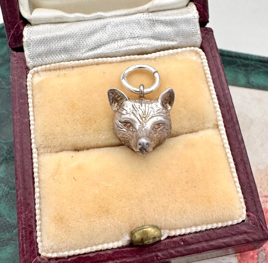 Silver fox pendant in a jewelry box with a white interior