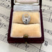 Silver heart-shaped lock pendant in a jewelry box on sheet music