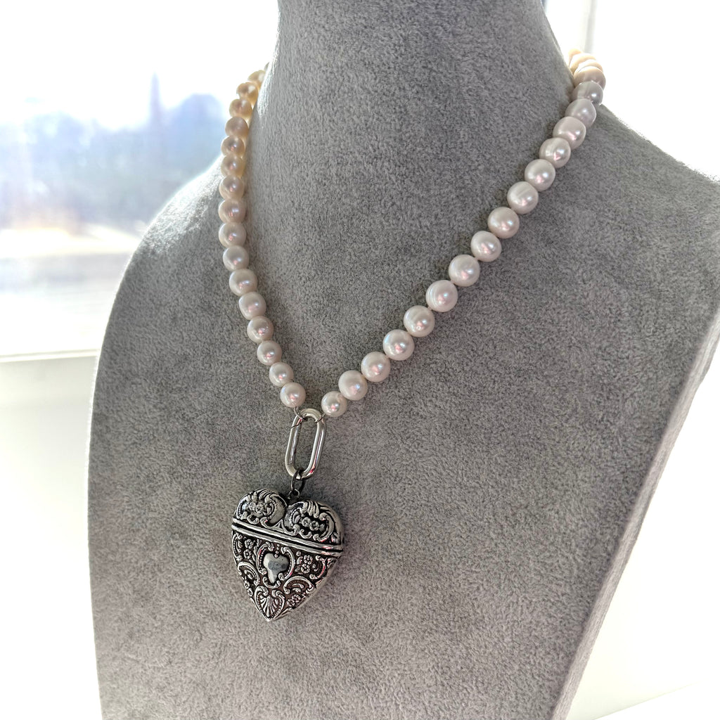 Vintage sterling silver repousse heart locket/pendant and pearl necklace on a mannequin