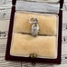 Silver vintage scarab beetle charm in a jewelry box on sheet music