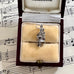 Silver bagpiper charm in a jewelry box on sheet music