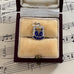 Vintage silver Crieff souvenir charm in a jewelry box on sheet music