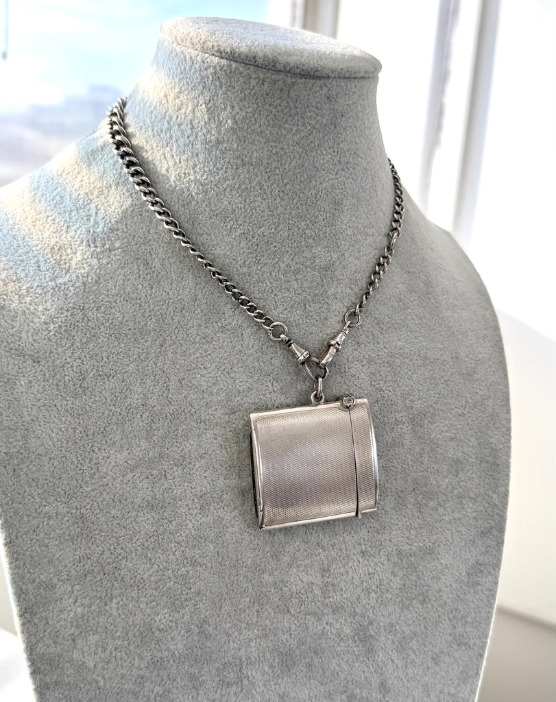 Vintage 1935 hallmarked vesta case made by G&SC Ltd of Regent St, London n an antique watch chain and on a grey mannequin