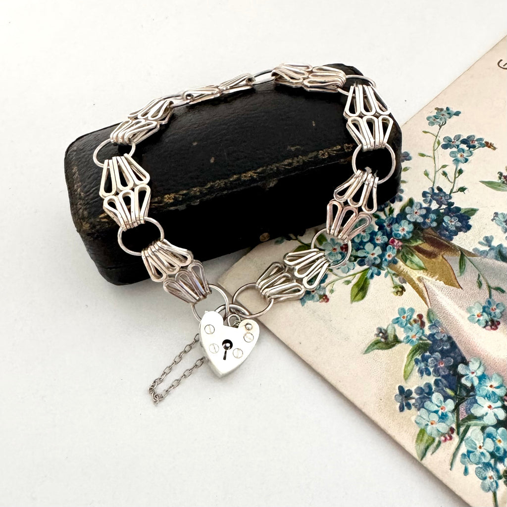 1976 silver bracelet with heart clasp on a floral card