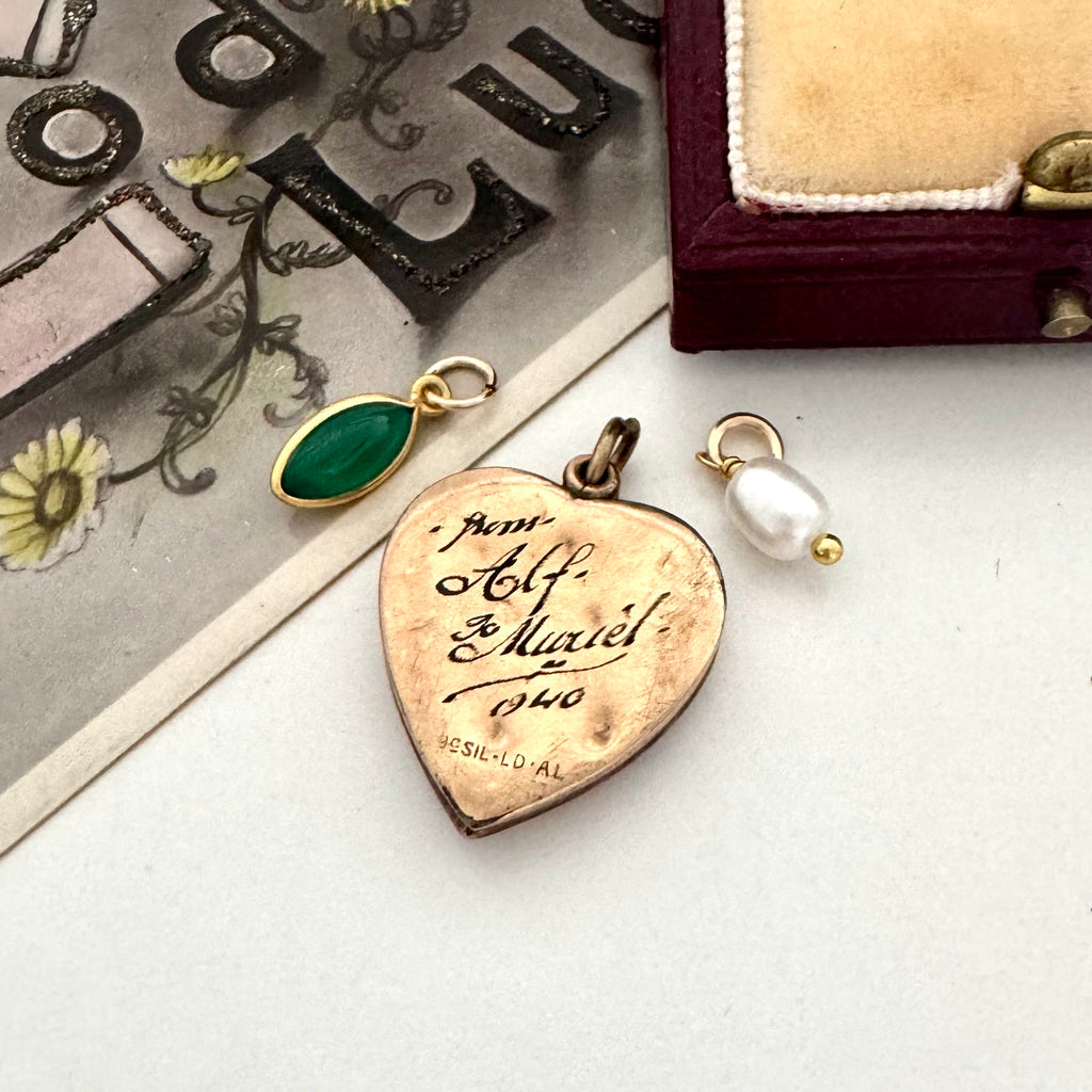 Vintage WW2 heart-shaped vintage pendant with engraved text on a white surface