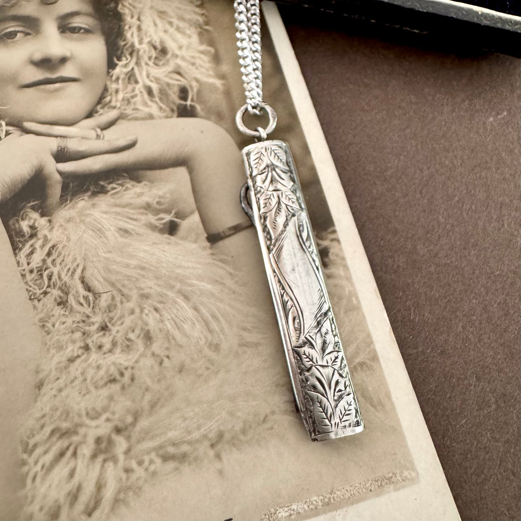 Vonk Jewellery 1894 silver button hook and pearl and lapis charm necklace on a vintage postcard and vintage jewellery box