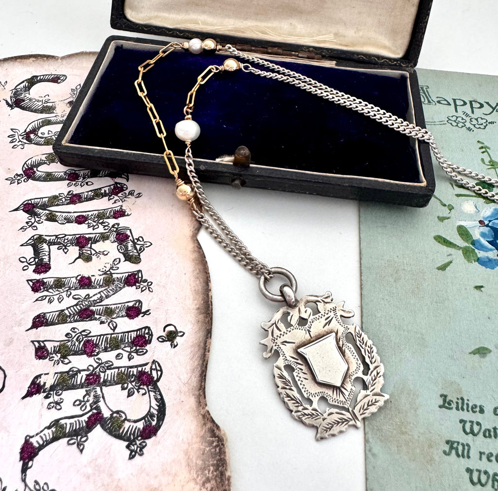 Vonk Jewellery 1898 sterling silver watch fob necklace with a vintage postcard and jewellery box