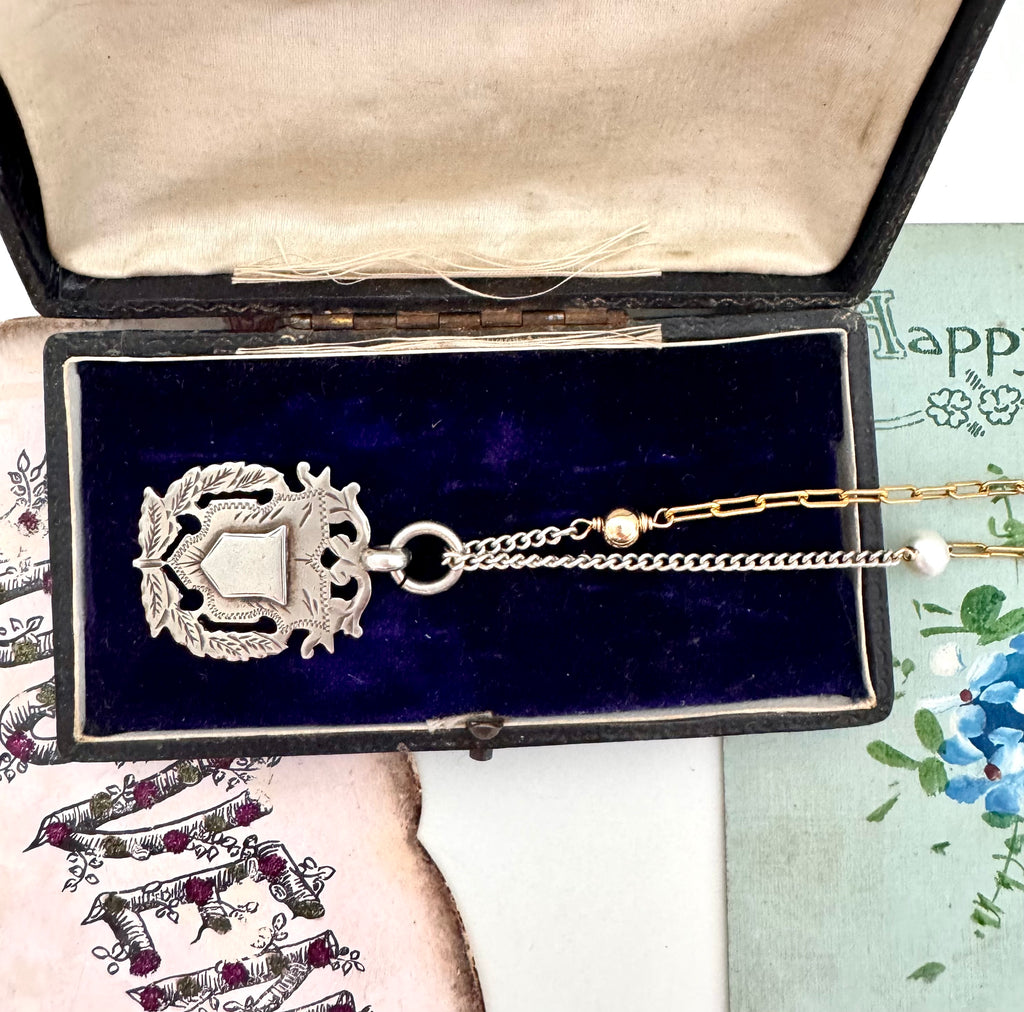 Vonk Jewellery 1898 sterling silver watch fob necklace with a vintage postcard and jewellery box