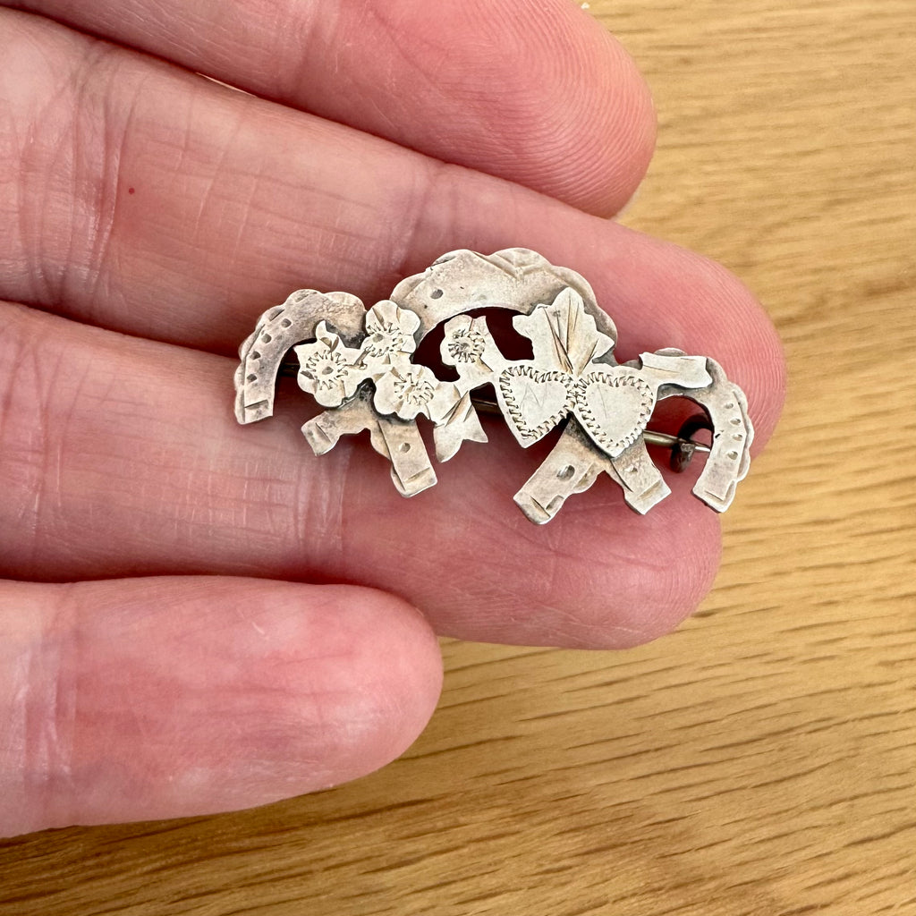 Vonk Jewellery antique sterling sivler 1917 sweetheart brooch in a womans hand