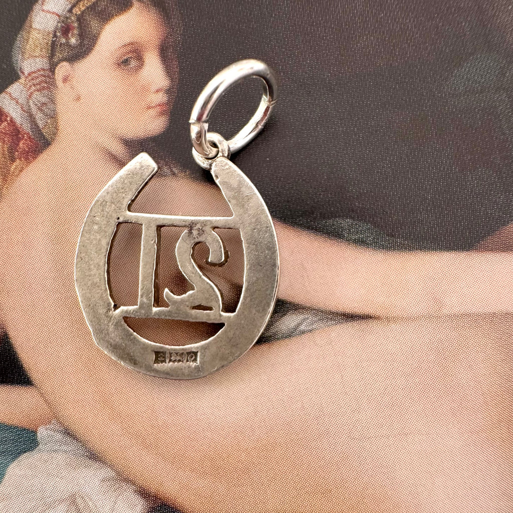 Vonk Jewellery 1963 hallmarked lucky horseshoe charm on an Ingres painting of a woman
