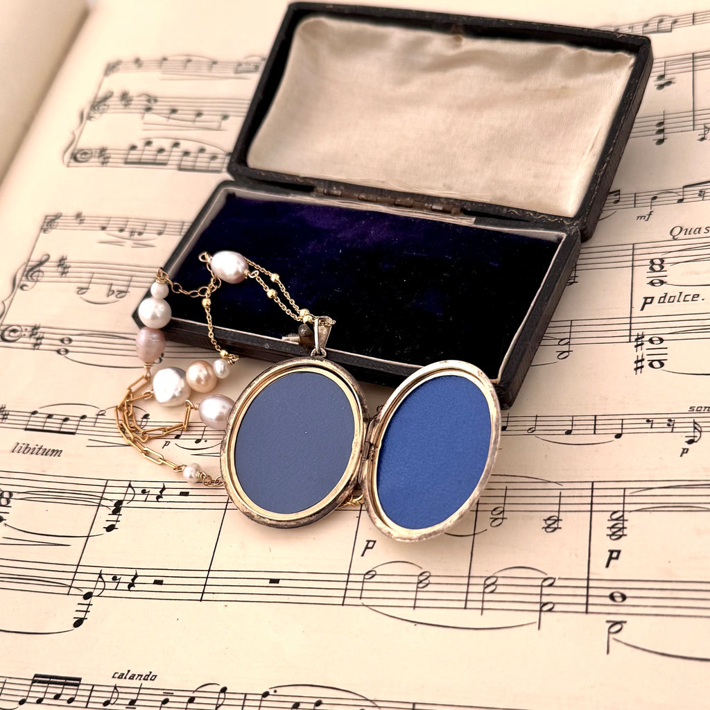 Vonk Jewellery vintage 1970 22ct gold plated locket necklace on a vintage jewellery box and music manuscript