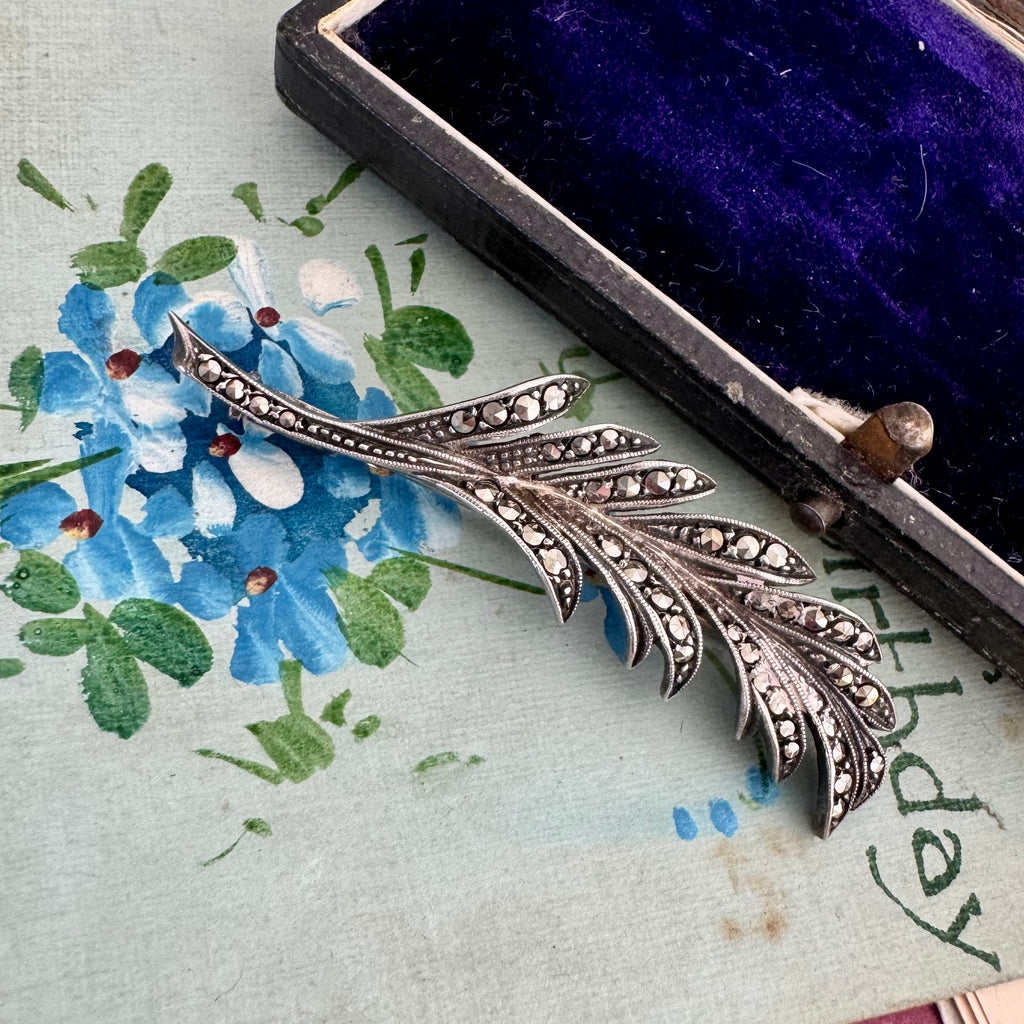 Vonk Jewellery French marcasite leaf brooch with trombone clasp on a vintage postcard and with a vintage jewellery box