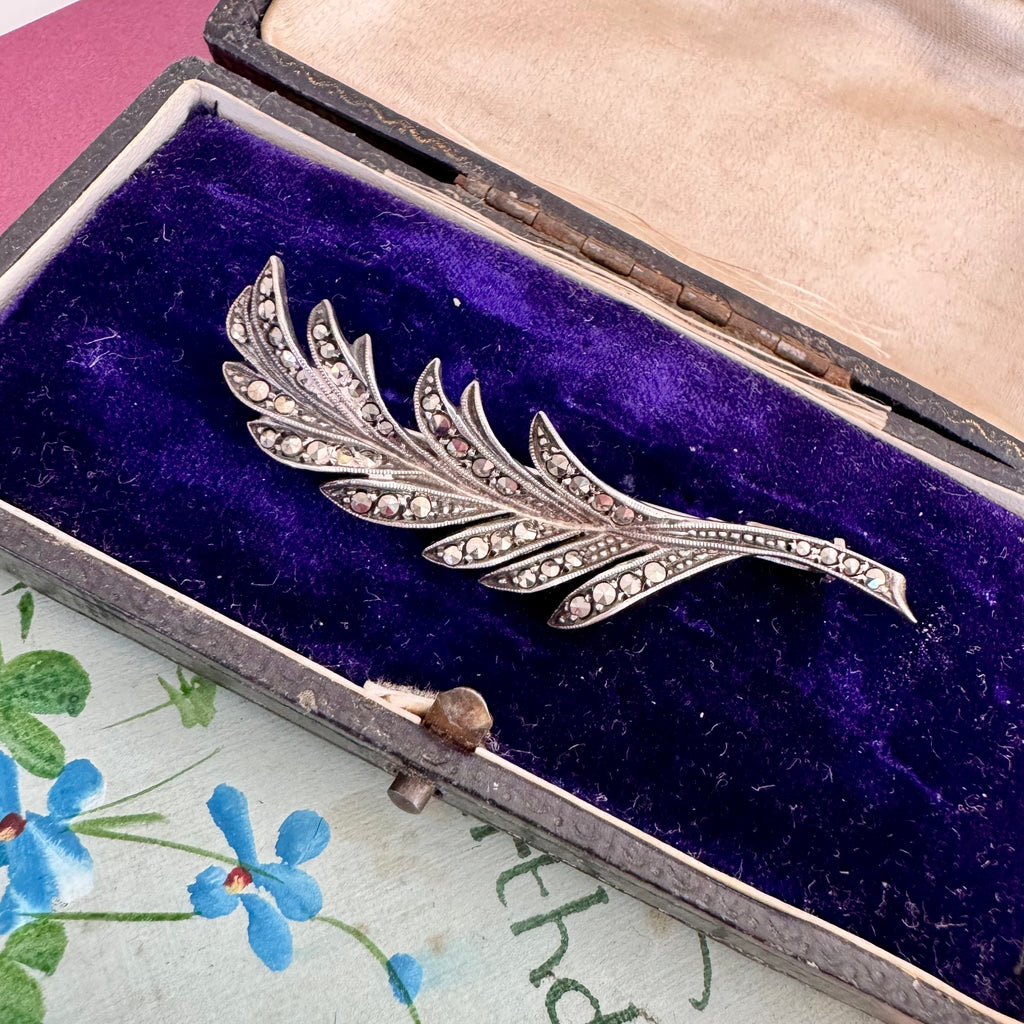 Vonk Jewellery French marcasite leaf brooch with trombone clasp on a vintage postcard and with a vintage jewellery box