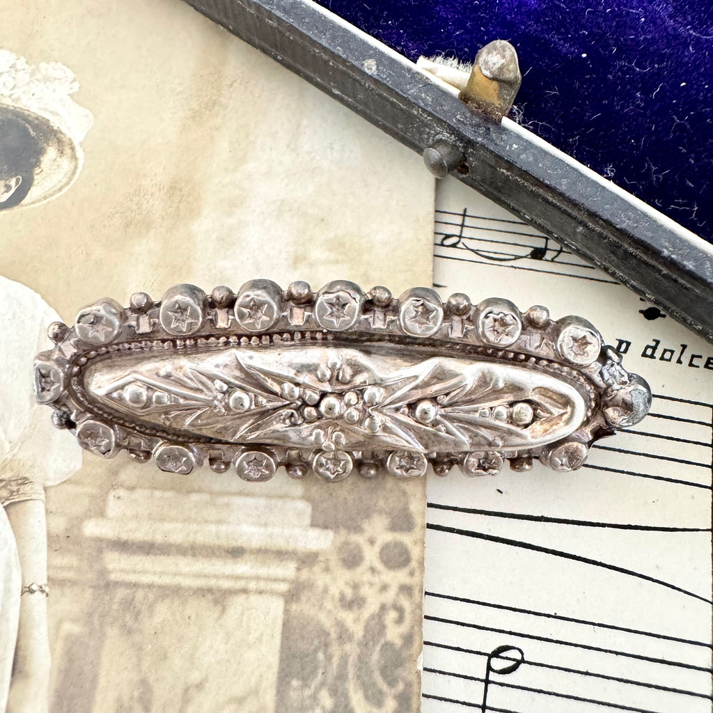 Vonk Jewellery Victorian 1889 silver brooch on a vintage postcard and with vintage sheet music