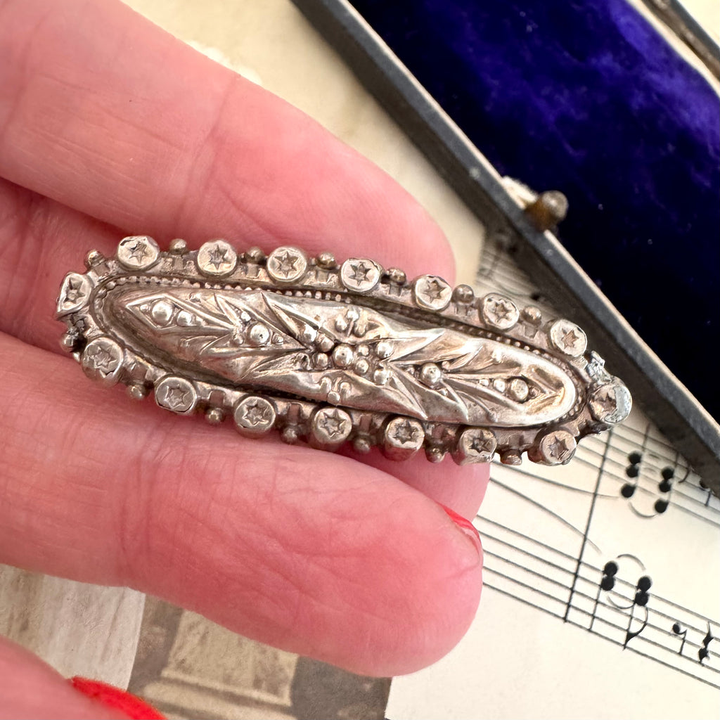 Vonk Jewellery Victorian 1889 silver brooch on a vintage postcard and with vintage sheet music