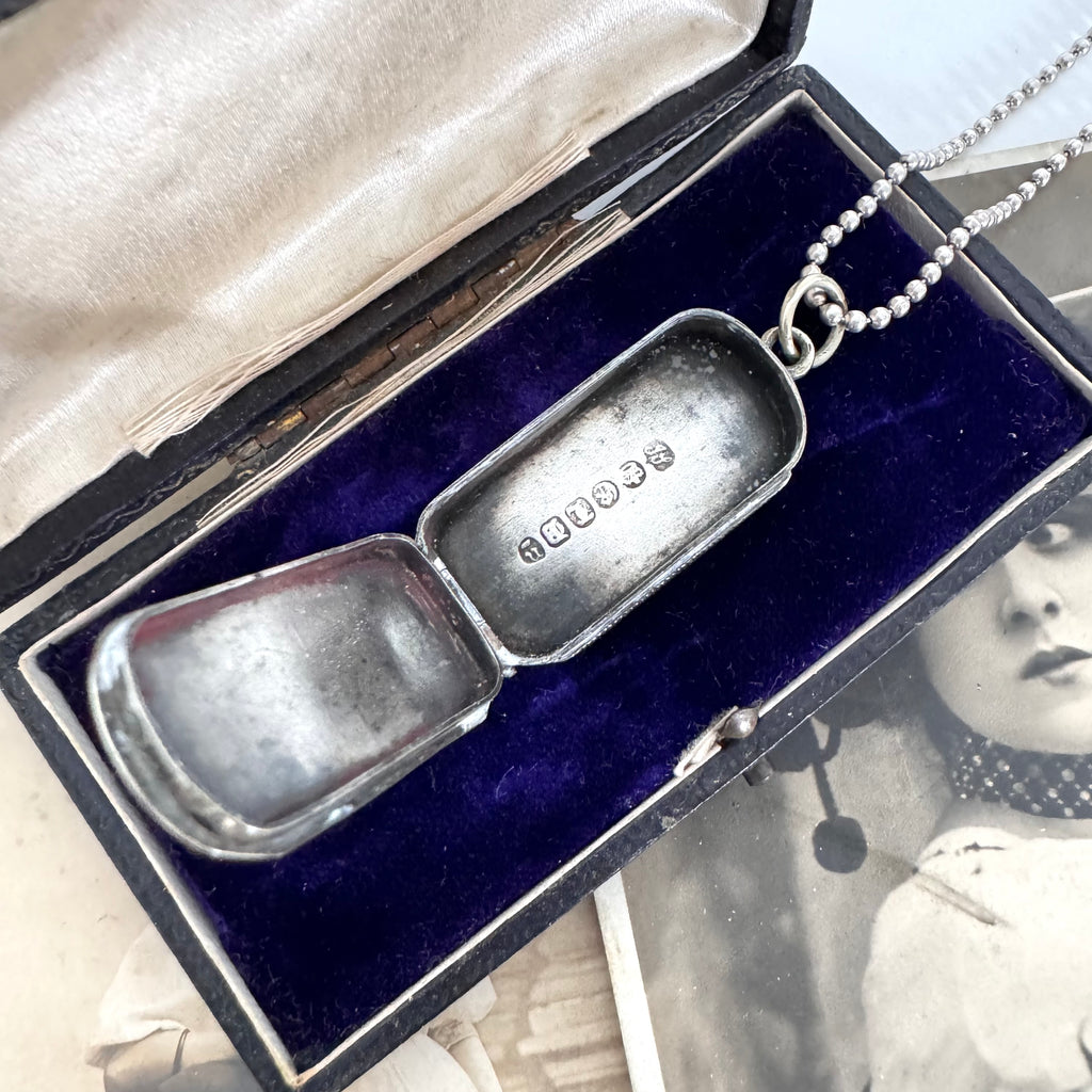 Vonk Jewellery antique vesta case necklace on a vintage jewellery box and with a vintage postcard of a woman.