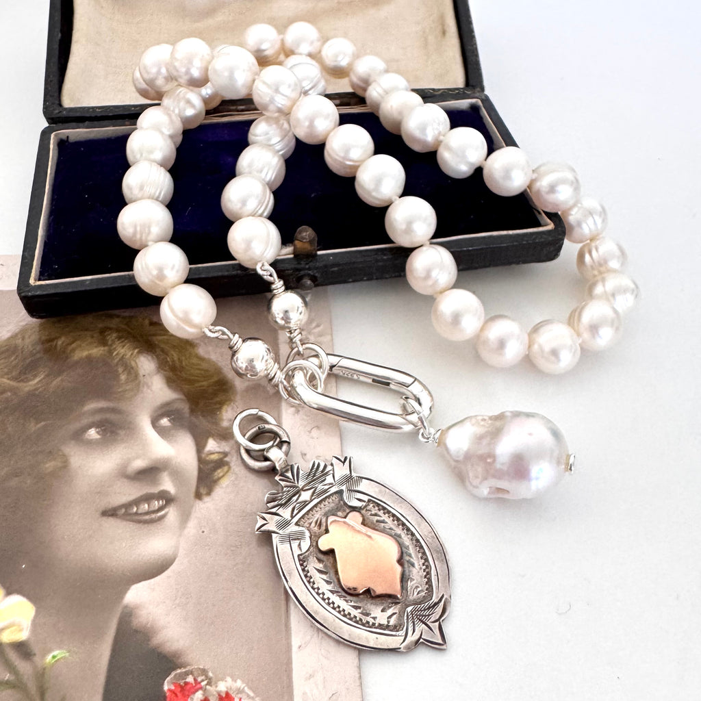 Vonk Jewellery 1931 watch fob and pearl necklace on a vintage postcard and vintage jewellery box