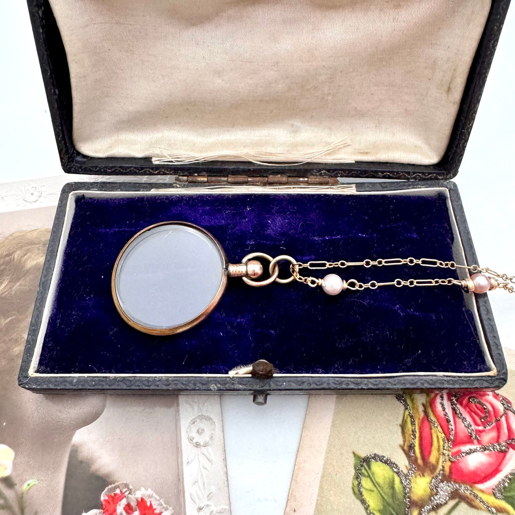 Vonk Jewellery rolled gold antique locket necklace on a vintage postcard and with a vintage jewellery box
