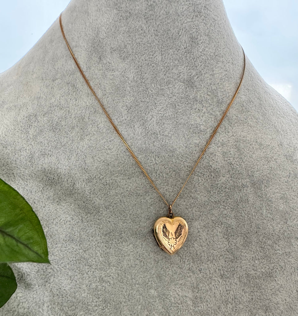 Vonk Jewellery rolled gold vintage heart locket on a grey jewellery display neck