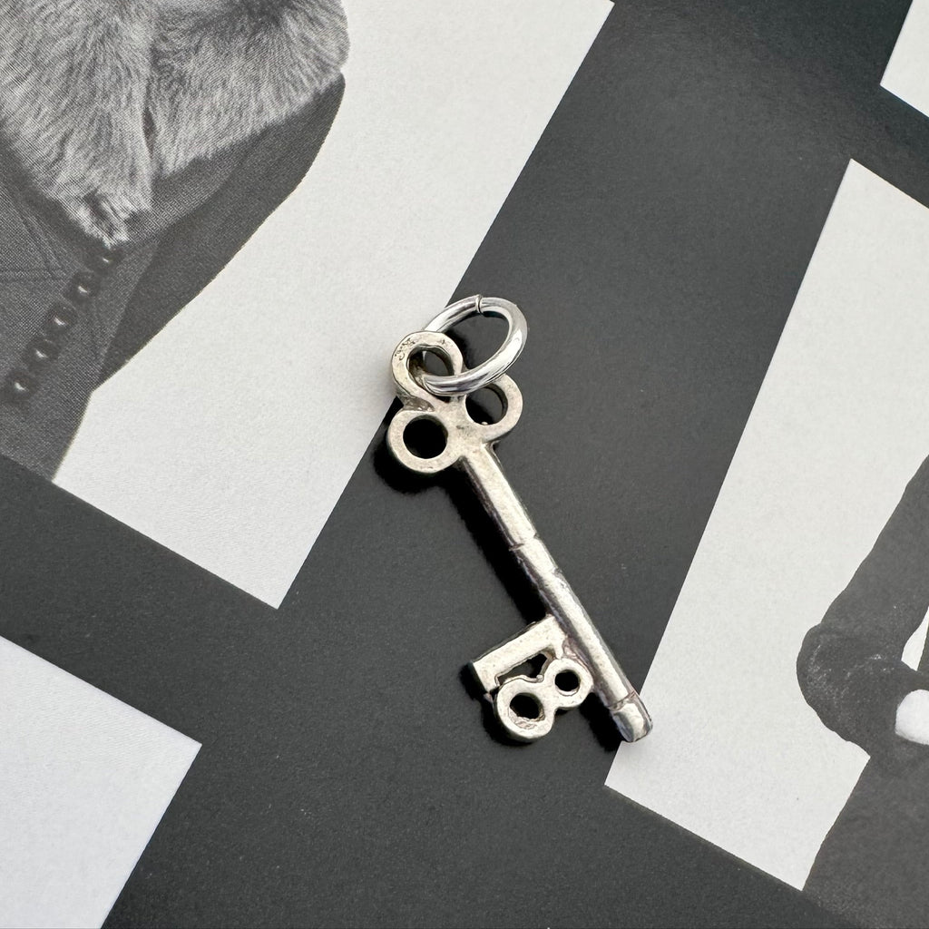 Vonk Jewellery vintage silver 18 Birthday key charm on a black and white image.