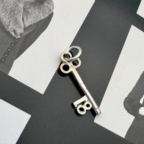 Vonk Jewellery vintage silver 18 Birthday key charm on a black and white image.