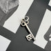 Vonk Jewellery vintage silver 18 Birthday key charm on a black and white image.