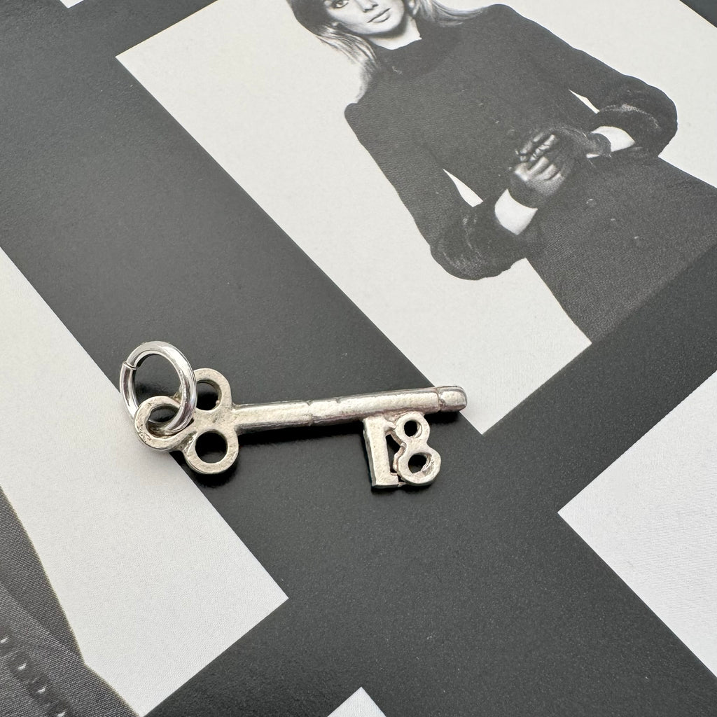Vonk Jewellery vintage silver 18 Birthday key charm on a black and white image of a model.