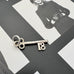 Vonk Jewellery vintage silver 18 Birthday key charm on a black and white image of a  model.