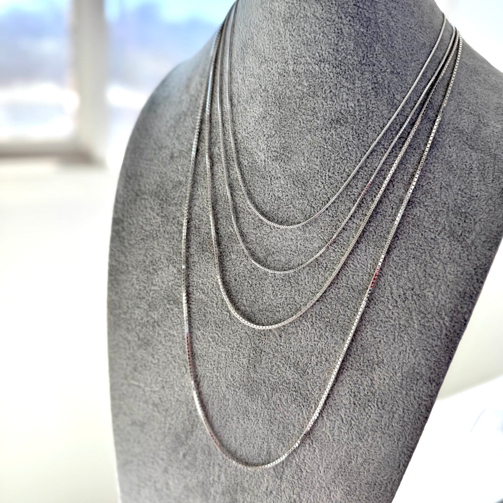 Vonk Jewellery sterling silver chains on a grey necklace stand