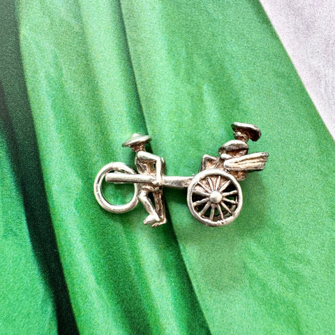 Vonk Jewellery vintage sterling silver rickshaw charm on a green background