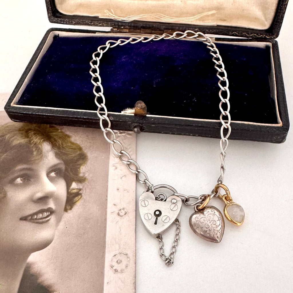 Vonk Jewellery vintage sterling silver heart clasp bracelet with a vintage charm and moonstone charm on a vintage postcard and jewellery box