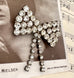 Vonk Jewellery vintage 1950's rhinestone bow brooch on a vintage postcard and vintage sheet music