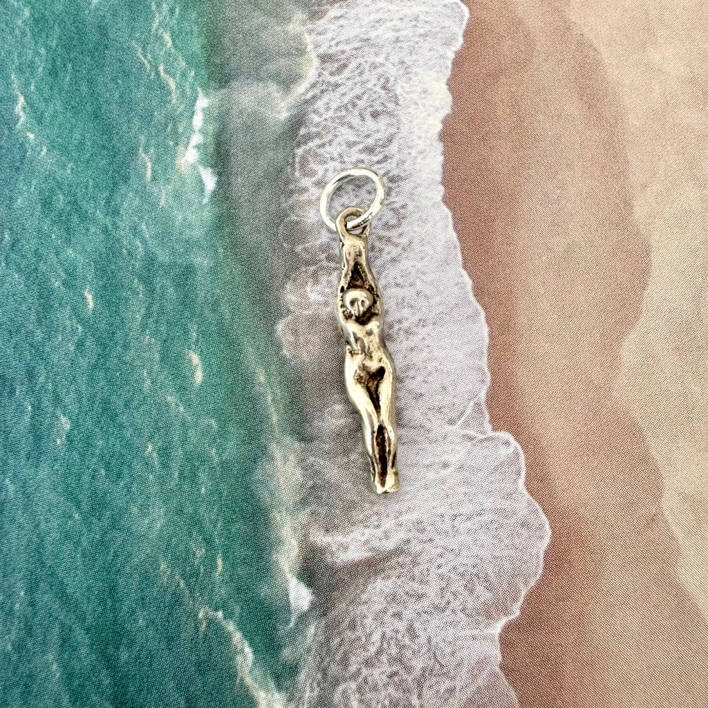 Vonk Jewellery vintage female swimmer or diver sterling silver charm on an image of the sand and sea