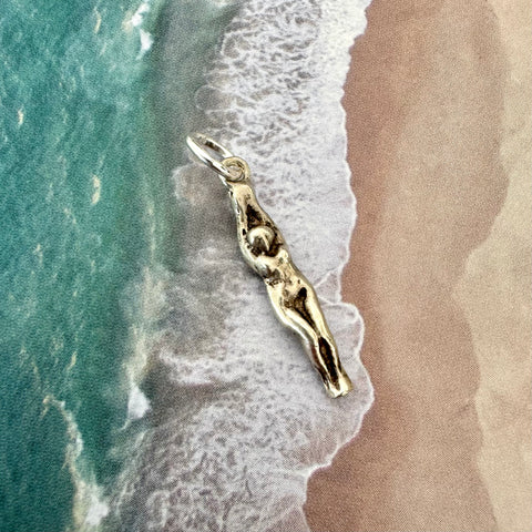 Vonk Jewellery vintage female swimmer or diver sterling silver charm on an image of the sand and sea