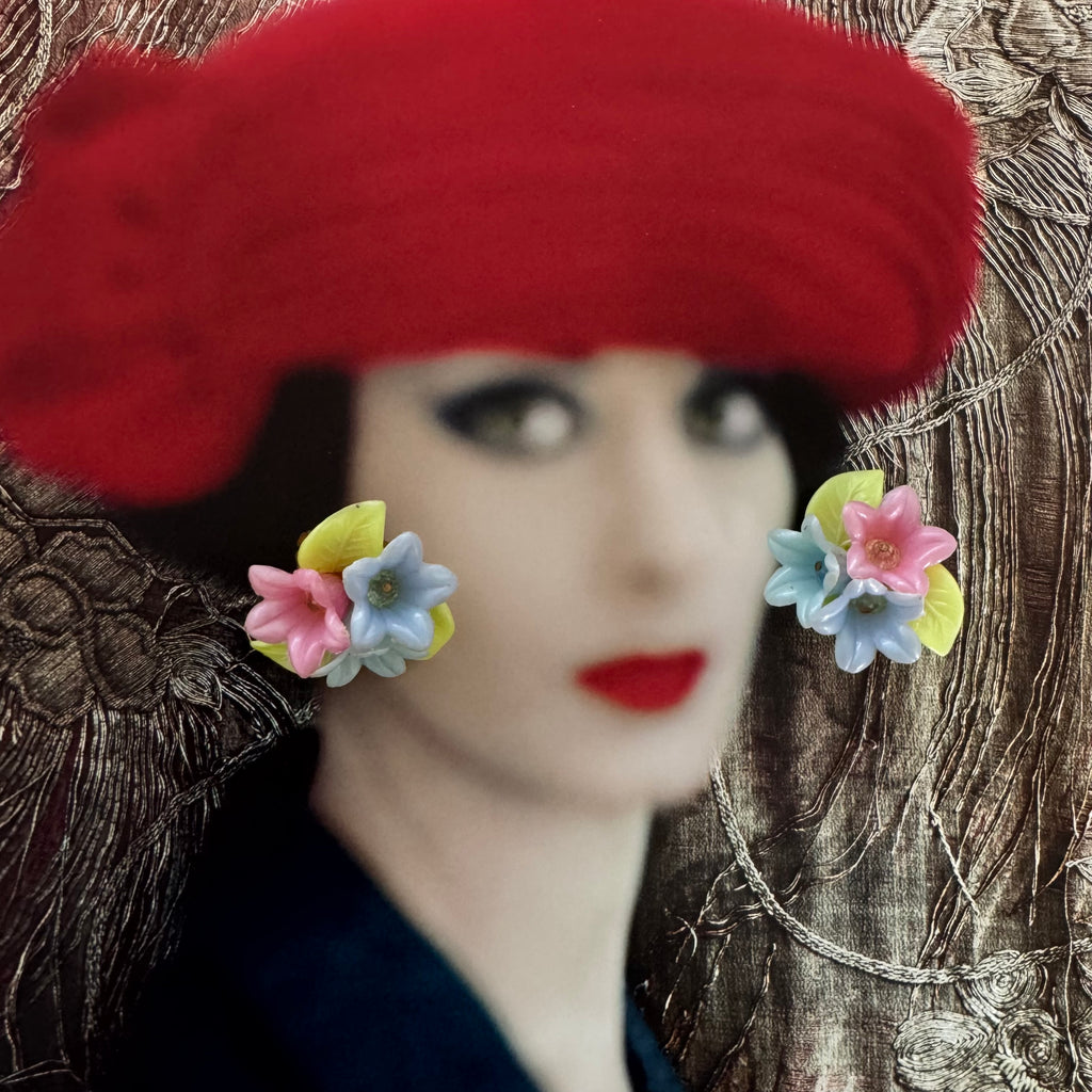 Vonk Jewellery West Germany vintage flower clip on earrings on a photo of a woman wearing a bright red hat