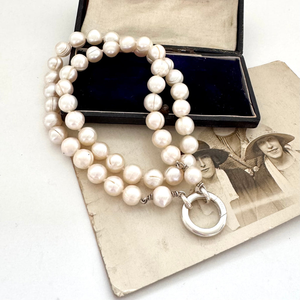 Pearl necklace with silver clasp on an old photograph
