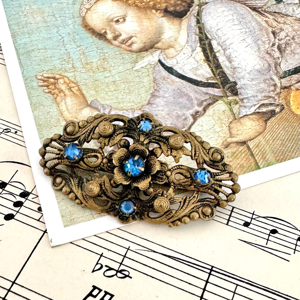 Vonk Jewellery antique made in Czechoslovakia blue stone brooch on a postcard of an angel and vintage sheet music