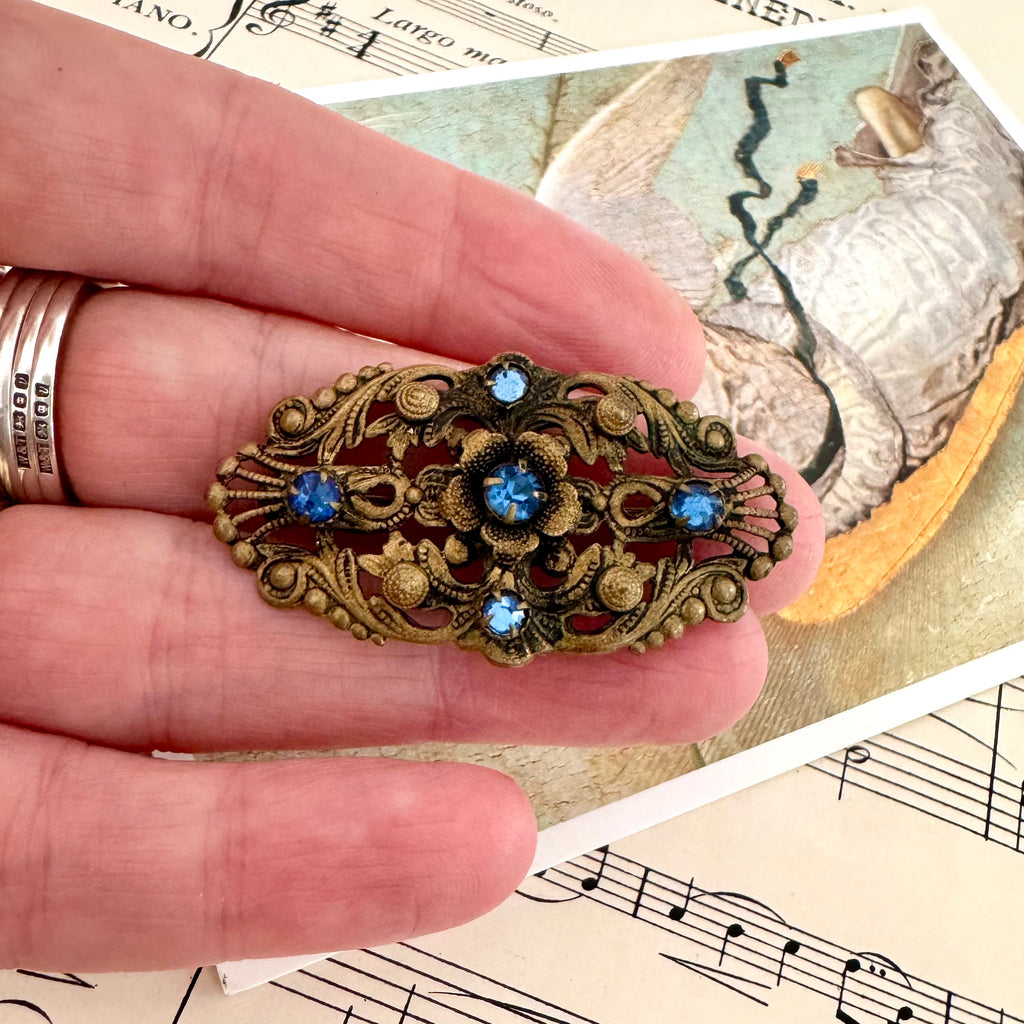 Vonk Jewellery antique made in Czechoslovakia blue stone brooch on a postcard of an angel and vintage sheet music