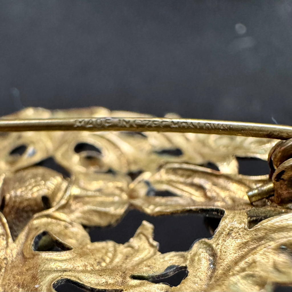 Close up of the pin of a Vonk Jewellery antique made in Czechoslovakia blue stone brooch