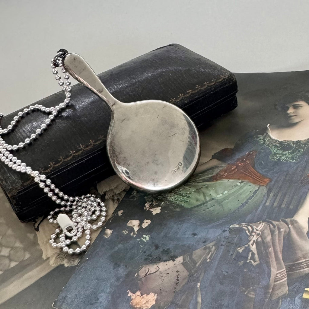 Vonk jewellery antique sterling silver hand mirror necklace on an antique box and with vintage postcards of a woman