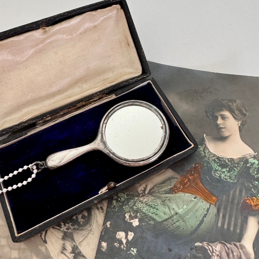 Vonk jewellery antique sterling silver hand mirror necklace on an antique box and with vintage postcards of a woman