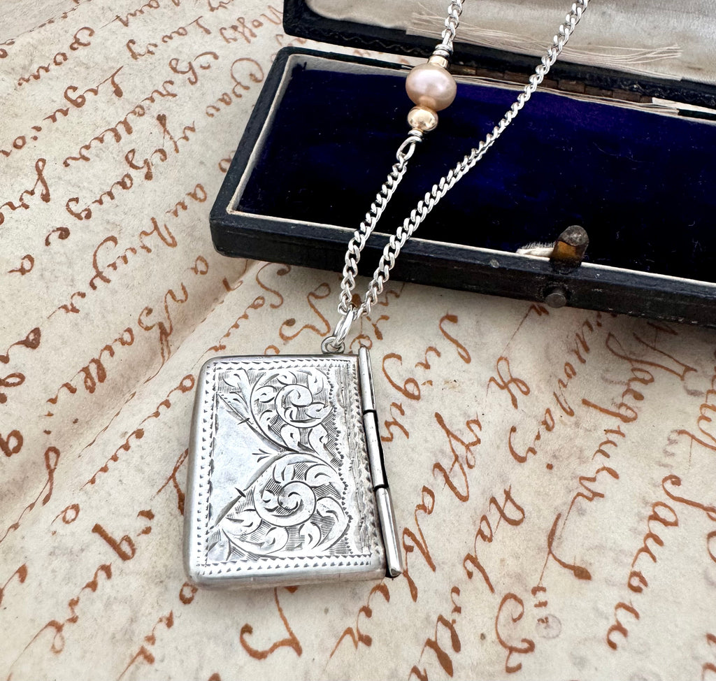 Vonk Jewellery 1905 sterling silver stamp necklace on an old manuscript and with a vintage jewellery box