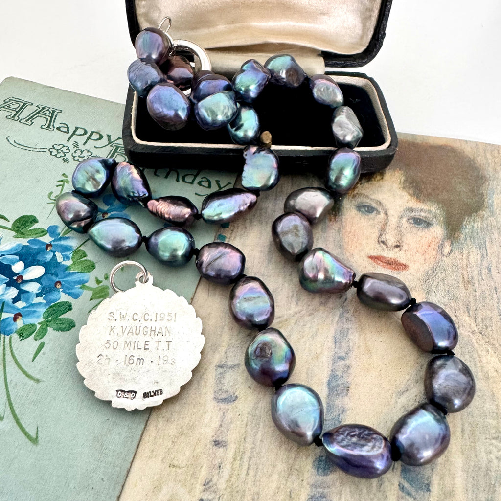 Vonk Jewellery peacock pearl and vintage silver watch fob necklace on 2 vintage postcards and with a vintage jewellery box