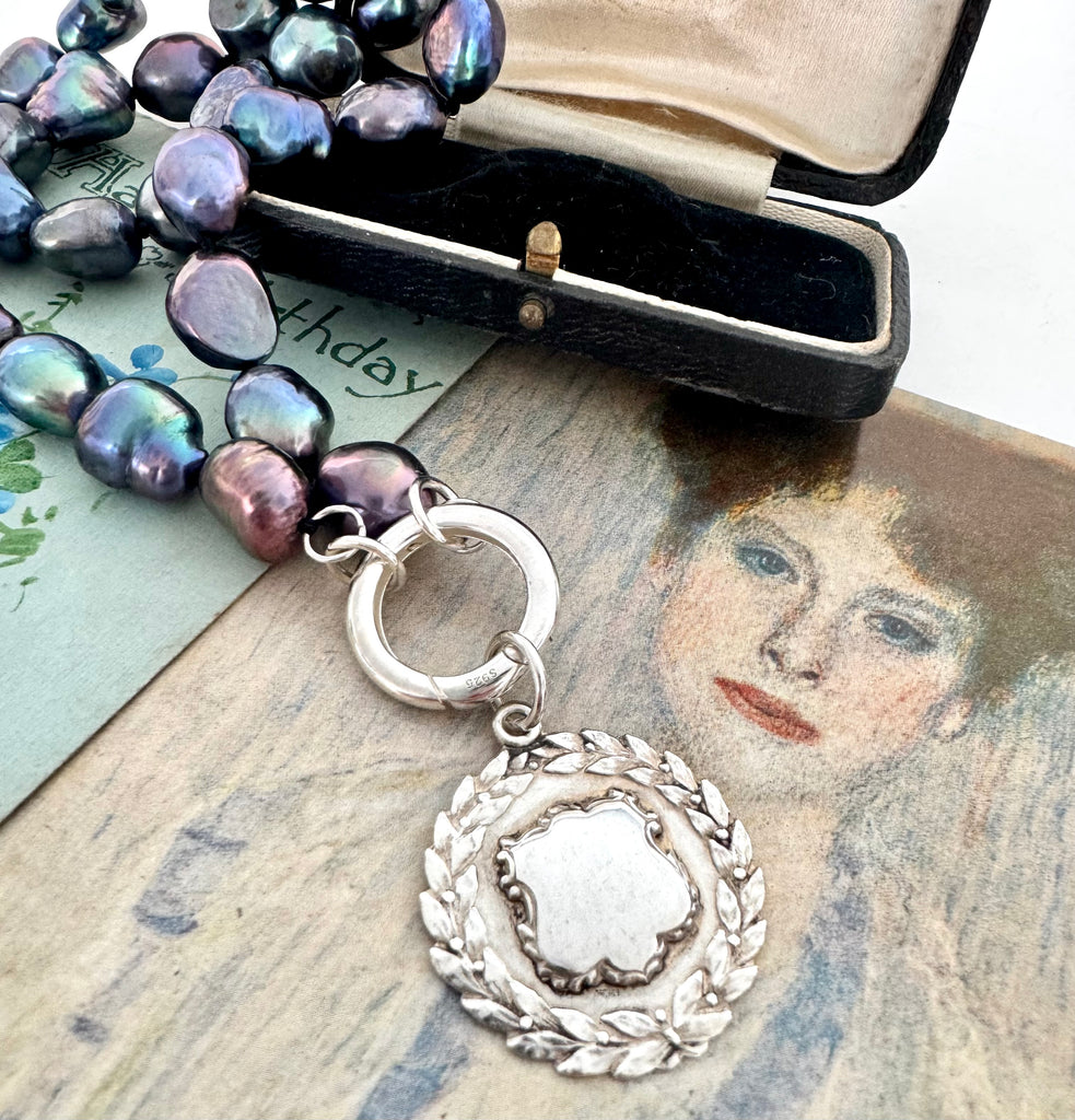 Vonk Jewellery peacock pearl and vintage silver watch fob necklace on 2 vintage postcards and with a vintage jewellery box