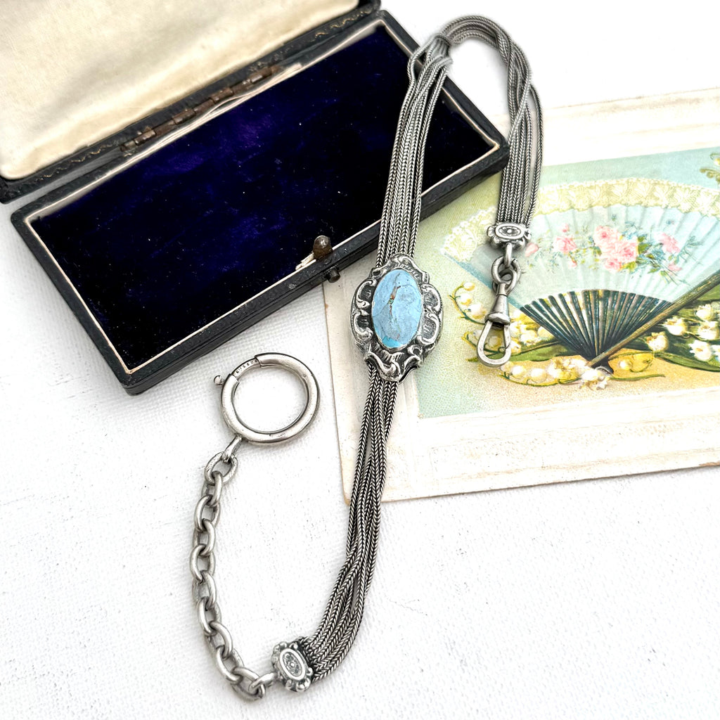 Antique French silver albertina chain , displayed next to its dark blue velvet box and a decorative fan card.