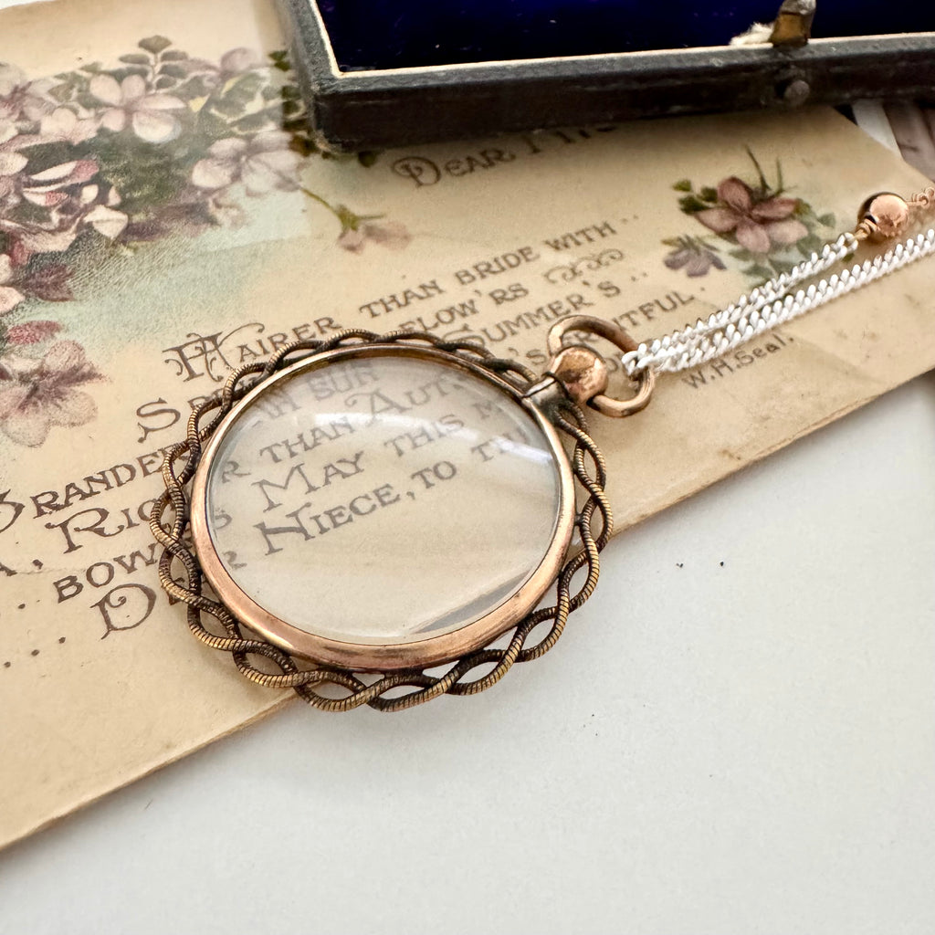 Vonk Jewellery antique rolled rose gold double sided photo locket necklace on a vintage postcard