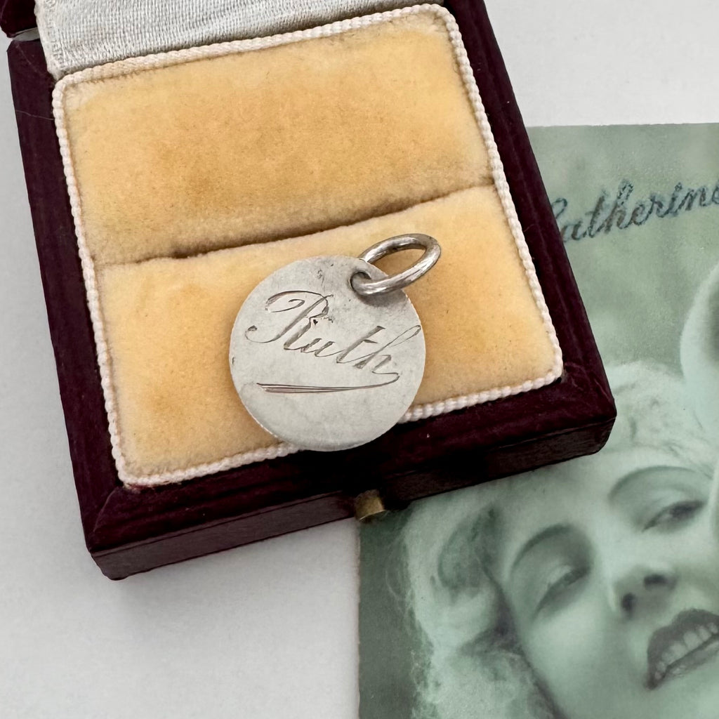 Silver pendant with 'Ruth' engraved in a wooden box