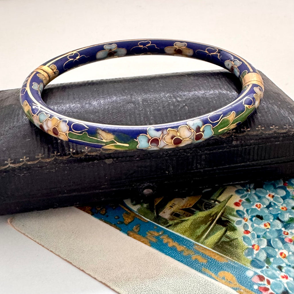 Vintage blue cloisonne bangle on an old jewellery box with a vintage Christmas postcard